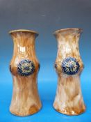 A pair of Royal Doulton vases decorated with floral medallions,