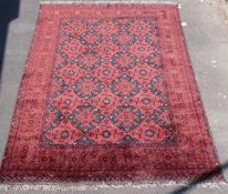 A large Afghan rug with wine ground (300 x 201cm)