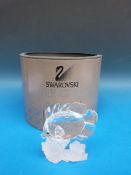 Swarovski crystal model of a butterfly fish swimming over coral,