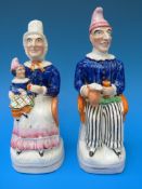 A pair of 19thC Staffordshire Toby figures of Punch and Judy (tallest 21cm)