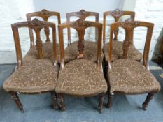 A set of six late 19thC carved oak upholstered chairs