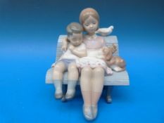 A Lladro figure 'Surrounded by Love' (16cm high)