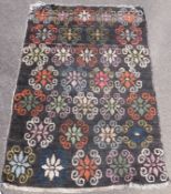 A red ground rug with repeating Maltese cross design in diamonds (152 x 83.