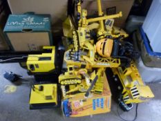 A collection of large scale model cranes and construction vehicles,