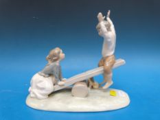 A boxed Lladro figure of children on a seesaw 