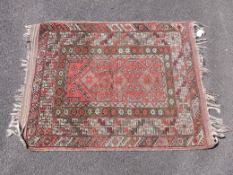 A wool prayer mat with red ground (113 x 86cm)