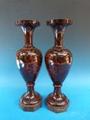 A pair of hardstone vases raised on octagonal marble bases