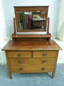 A late 19thC/ early 20thC dressing chest with swing frame mirror above,
