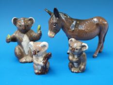 Three Beswick koalas and a donkey