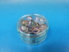 Eighteen glass marbles all with multicoloured swirl and latticino decoration.