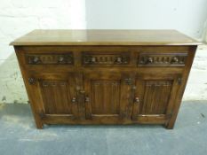 An Old Charm style sideboard fitted three drawers over three cupboards (W139, D46,