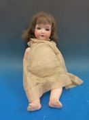 An early 20thC German bisque doll with jointed body and weighted eyes (height 36cm)