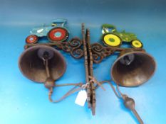 Two wall mounted cast bells with vintage tractor atop