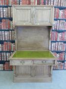 An unusual vintage pine leather inset desk / dresser with two cupboards above,
