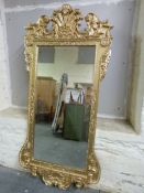 Two ornate framed mirrors with bevelled glass,