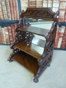 A late Victorian mahogany free standing three tier shelf unit with mirror back (H49cm)