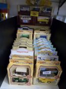 A collection of boxed toy cars including Lledo,