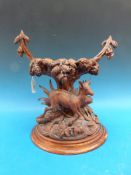 A Black Forest carved deer table centrepiece