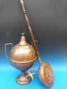 A copper and brass samovar and a warming pan