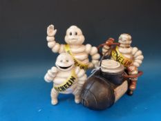 A replica Michelin compressor style figure and two other Michelin figures