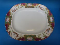 A large 19thC shaped meat platter with hand decorated scrolling decoration of exotic birds and