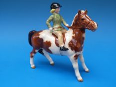 A Beswick girl on a skewbald pony