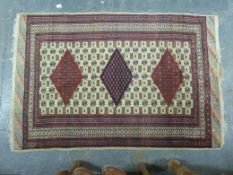 A wool rug with geometric design on beige ground (186 x 126cm)