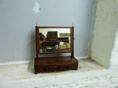 A Georgian mahogany and line inlaid swing frame mirror with two drawers below,