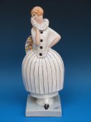 A French porcelain Art Deco figure of a lady dressed as a harlequin (33.