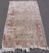 A Persian rug with bird decoration on beige ground