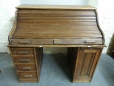 An oak twin pedestal roll top desk (W122, D77,