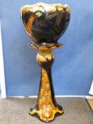 An Art Nouveau jardiniere and stand in the form of a peacock,