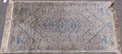 A blue and ivory silk rug (133 x 70cm)