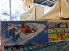 Three boxed model boats, a Yamaha speed boat,