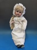 A JD Kestner bisque headed doll with open mouth,