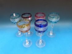 A set of six flash overlaid cut wine glasses raised on hexagonal stems with cut bases, 19.5cm tall.