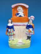A rare 19thC Staffordshire flatback figure of a Punch and Judy show (22cm tall)