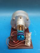 A Tesla steam turbine in fixed case driving direct to a generator and lighting three bulbs