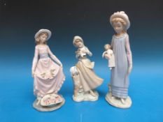 Three Lladro ladies: a girl with a doll,