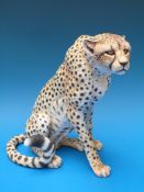 A large ceramic cheetah marked TA to base, 24cm tall.