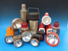 A collection of vintage torches and flasks,