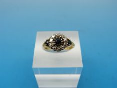 An 18ct gold ring set with sapphires and diamonds (one stone replaced)