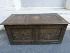 An antique oak coffer with carved decoration (W131cm, D62cm,
