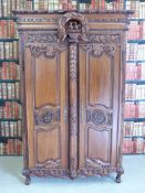 A heavily carved French walnut armoire (W137cm, D71cm,
