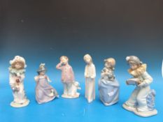 Five Nao children, two dressed as clowns, a girl with chamber sticks,