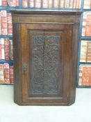 An oak corner cupboard with carved door (Height 98cm)
