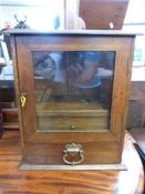An oak smokers cabinet with pipe rack, two drawers below,