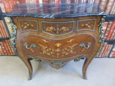 A Louis XV style kingwood marble topped bombe chest of three over one drawers with gilt mounts and