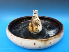 A large circular studio pottery dish,