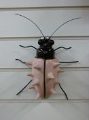 A signed Adrian Holt ceramic exotic insect in a pale pink colourway (25cm)